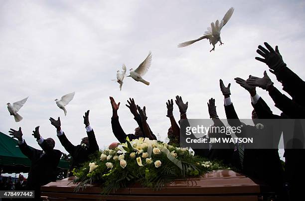 Pallbearer release doves over the casket holding Emanuel AME Church shooting victim Ethel Lance during her burial at the Emanuel AME Church Cemetery...