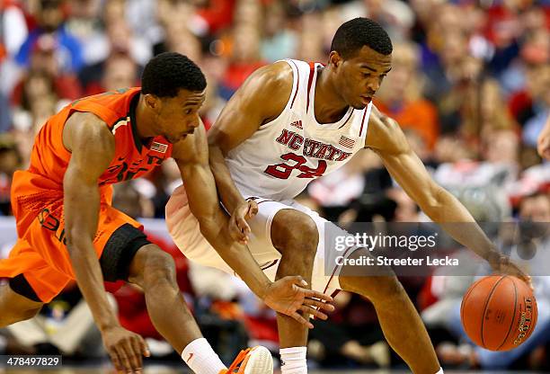 Garrius Adams of the Miami Hurricanes goes after a loose ball against T.J. Warren of the North Carolina State Wolfpack during the second round of the...
