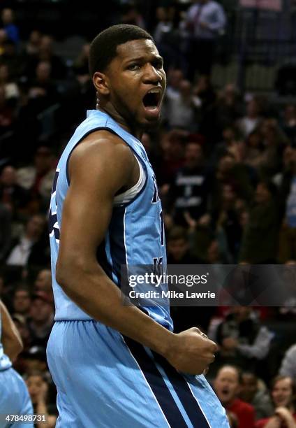 Hassan Martin of the Rhode Island Rams celebrates after a dunk in the first half against the Massachusetts Minutemen in the Second Round of the 2014...