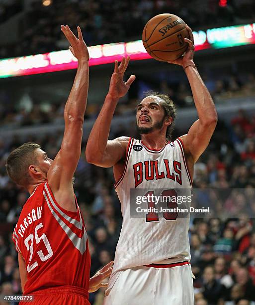 Joakim Noah of the Chicago Bulls shoots over Chandlker Parsons of the Houston Rockets at the United Center on March 13, 2014 in Chicago, Illinois....