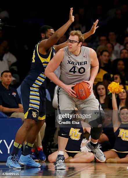 Matt Stainbrook of the Xavier Musketeers tries to get around Davante Gardner of the Marquette Golden Eagles during the quarterfinals of the Big East...