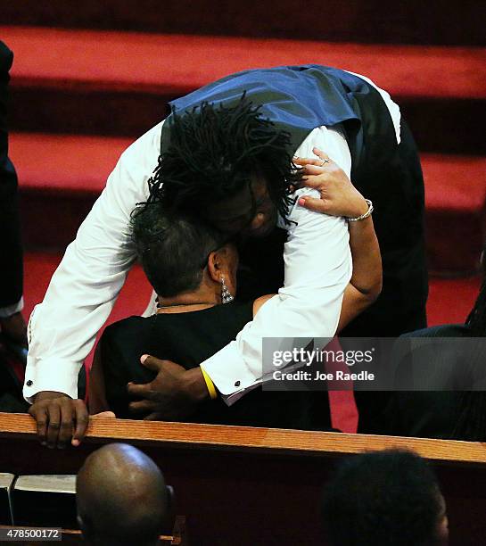 Brandon Risher comforts his mother, Sharon Risher, during the funeral service for her mother, Ethel Lance who was one of nine victims of a mass...