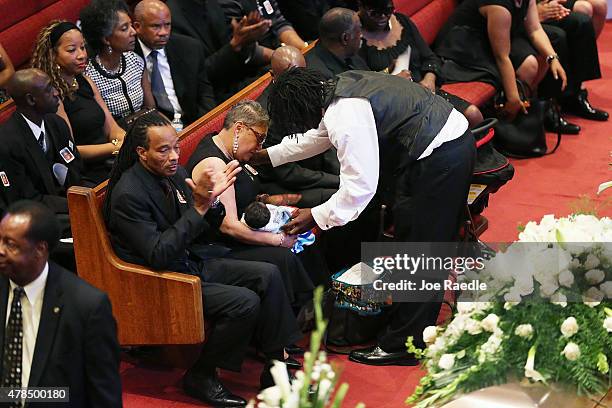 Brandon Risher comforts his mother, Sharon Risher, during the funeral service for her mother, Ethel Lance who was one of nine victims of a mass...