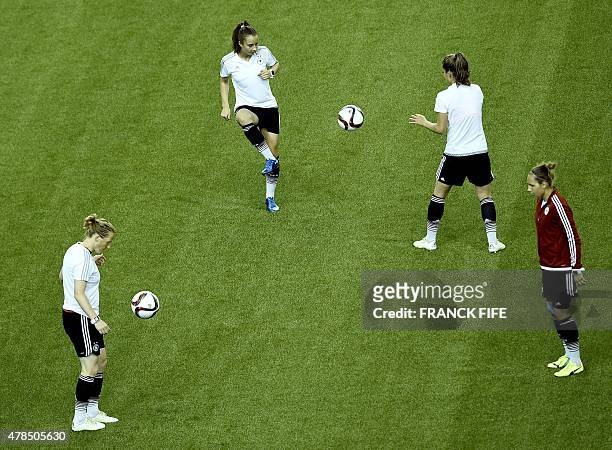 Germany's players attends in a training session at the Olympic Stadium in Montreal on June 25, 2015 on the eve of France's 2015 FIFA Women's World...