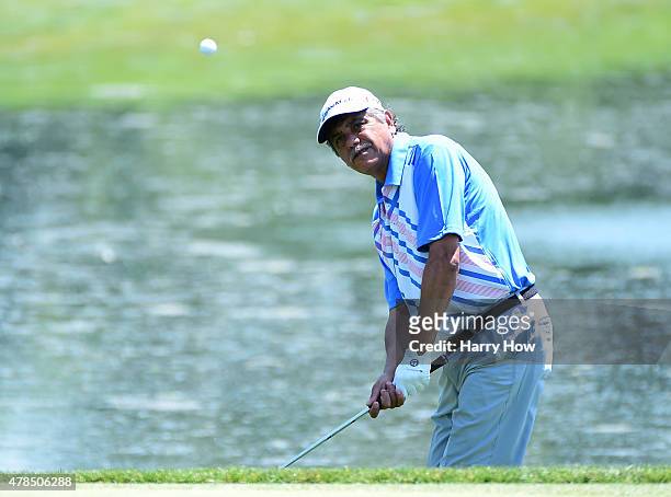 Eduardo Romero of Argentina hits of the rough on the 16th green during round one of the U.S. Senior Open Championship at the Del Paso Country Club on...