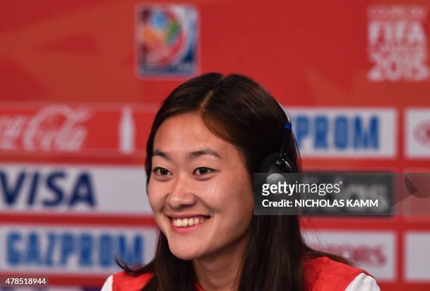 China's national team defender Wu Haiyan smiles during a press conference at Lansdowne Stadium in Ottawa on June 25, 2015 on the eve of their 2015...