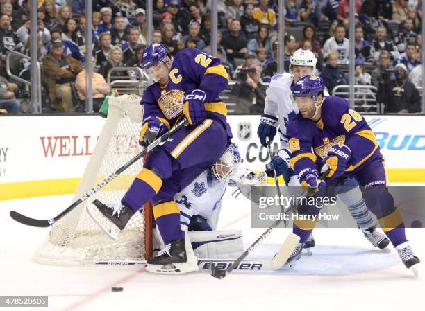 James Reimer of the Toronto Maple Leafs makes a save on Dustin Brown of the Los Angeles Kings as Jarret Stoll and Jake Gardiner look for a rebound...