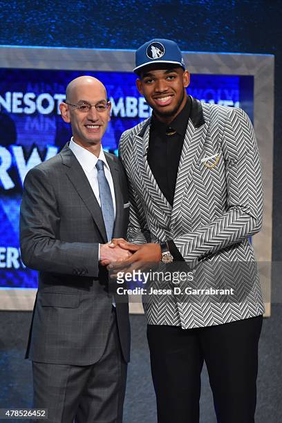 Karl-Anthony Towns the pick overall in the 2015 NBA Draft by the Minnesota Timberwolves poses for a portrait with Adam Silver during the 2015 NBA...