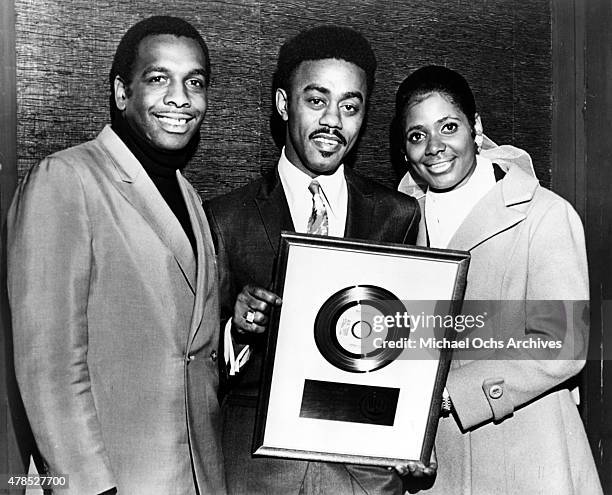 Stax Records executive William Bell, soul singer Johnnie Taylor and Carla Thomas pose for a portrait with Johnnie Taylor's gold record plaque circa...