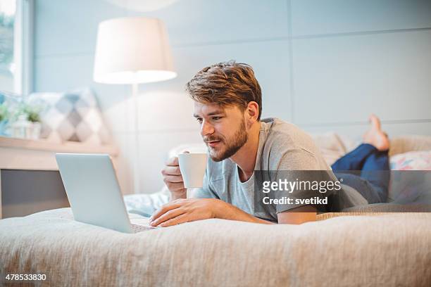 young man enjoying at home. - blonde man stockfoto's en -beelden