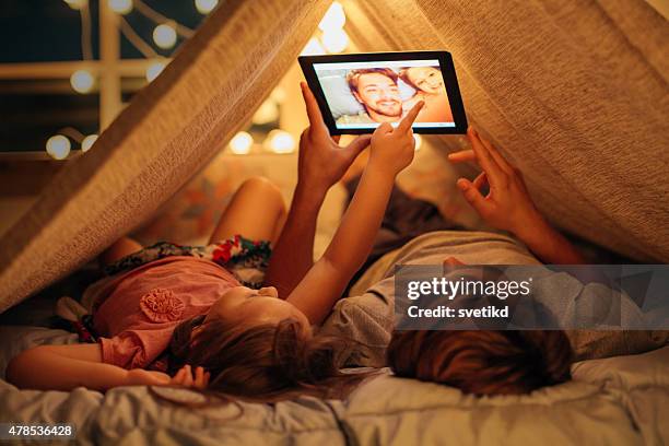 father and daughter enjoying at home. - camping indoors stock pictures, royalty-free photos & images