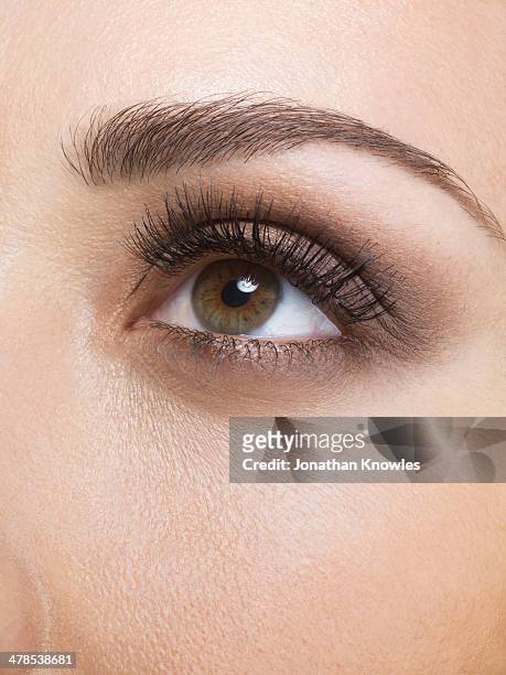female eye looking up, close up - brown eye stock pictures, royalty-free photos & images