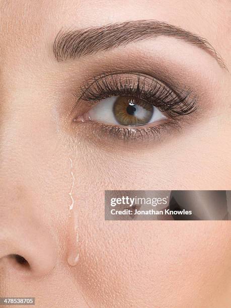 tears down female face, close up - tear face photos et images de collection