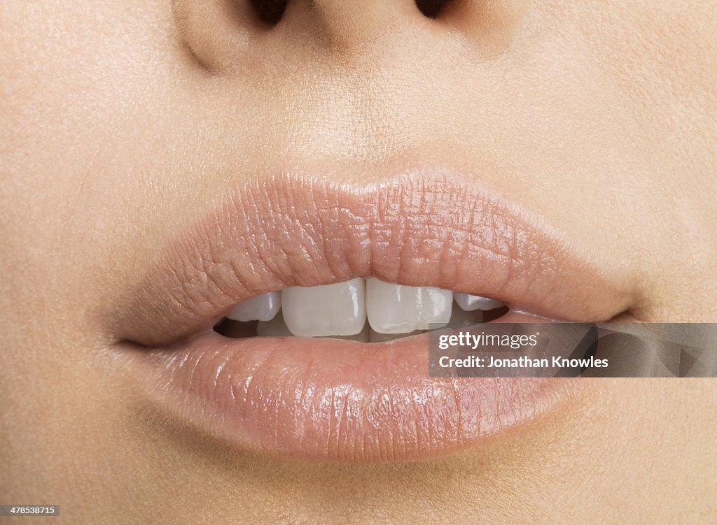 Young woman, close up on mouth with perfect teeth