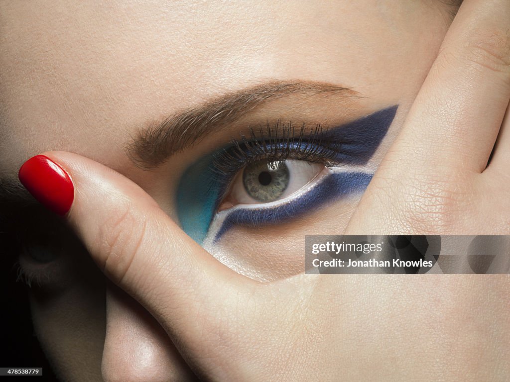 Female holding her fingers over one of her eyes