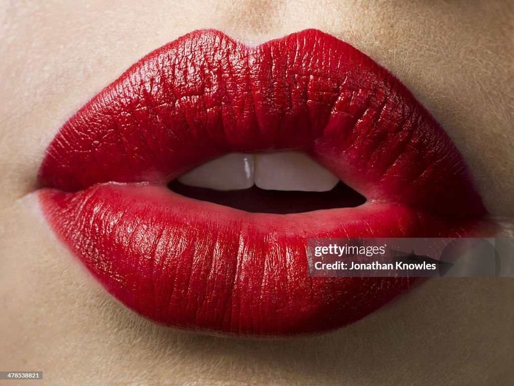 Female lips with red lipstick on, close up