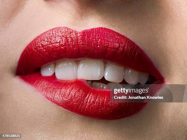 female with red lipstick, biting lips, close up - alluring bildbanksfoton och bilder