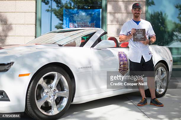 The winner of Crown Royal's "Your Hero's Name Here" program, retired U.S. Marine Corps Sergeant Jeff Kyle stands in front of an official pace car...