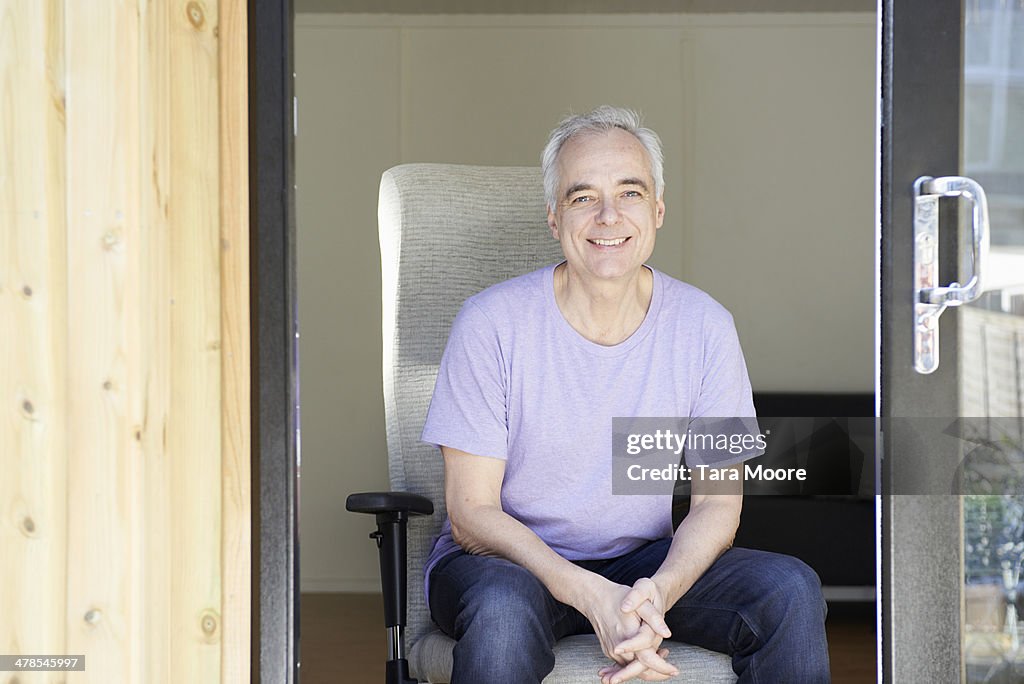Mature man sitting in home office