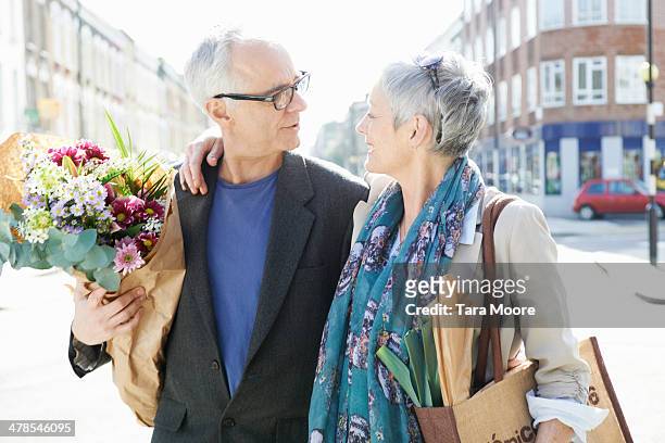 mature man and woman on street with shopping