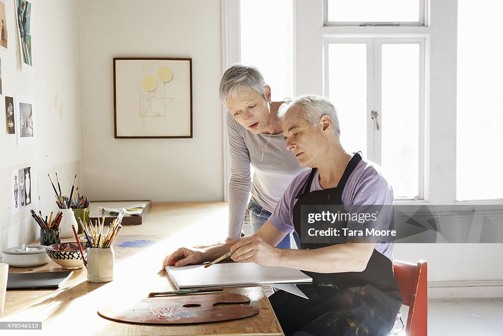 Mature man and woman in artist's studio