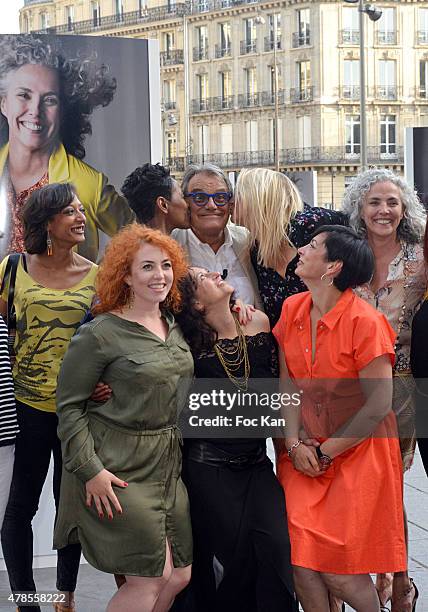 Photographer Oliviero Toscani poses with his models during 'Anti Cliches' Outdoor Exhibition Preview Hosted by Olivier Toscani and Balsamik at Lazare...