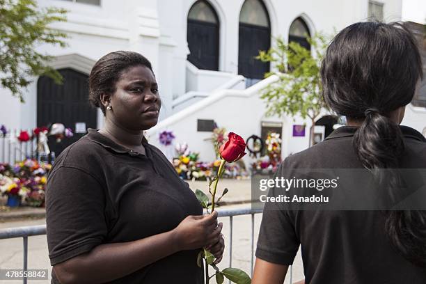 Woman brings a rose to place in front of Emanuel African Methodist Episcopal Church, a historic black church, where Dylann Roof, a self declared...