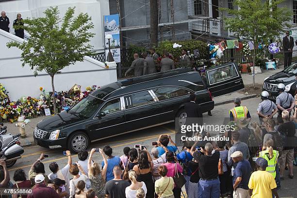 The body of Reverend Clementa Pinckney is being carried into Emanuel African Methodist Episcopal Church, a historic black church, who was murdered at...
