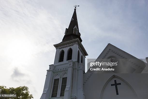 Mourners gather in front of Emanuel African Methodist Episcopal Church, a historic black church, where Dylann Roof, a self declared White...