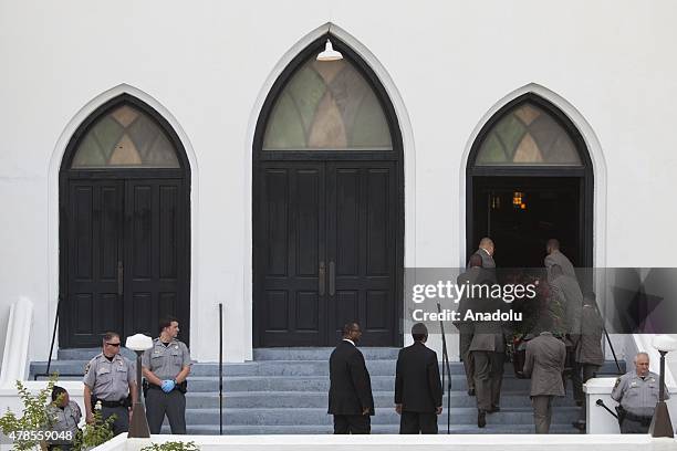 The body of Reverend Clementa Pinckney is being carried into Emanuel African Methodist Episcopal Church, a historic black church, who was murdered at...