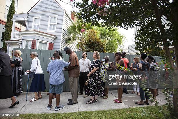 Mourners line up around the block to enter Emanuel African Methodist Episcopal Church, a historic black church, for a viewing of Reverend Clementa...