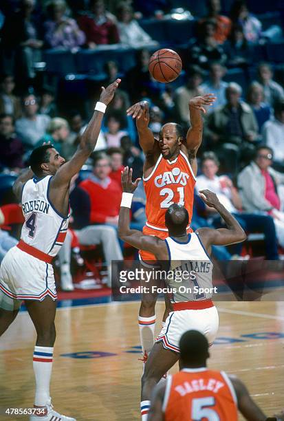 World B. Free of the Cleveland Cavaliers shoots over Cliff Robinson and Gus Williams of the Washington Bullets during an NBA basketball game circa...