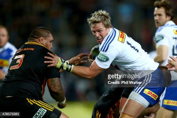 Jean De Villiers of the Stormers fends off Ben Tameifuna of the Chiefs during the round five Super Rugby match between the Chiefs and the Stormers at...