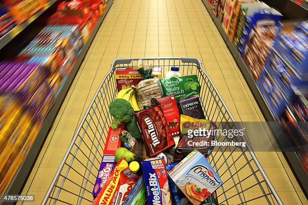 Merchandise sit inside a shopping cart at an Aldi Stores Ltd. Food store in Sydney, Australia, on Thursday, June 25, 2015. Australia's biggest...