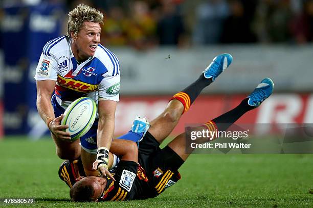 Jean De Villiers of the Stormers is tackled by Aaron Cruden of the Chiefs during the round five Super Rugby match between the Chiefs and the Stormers...