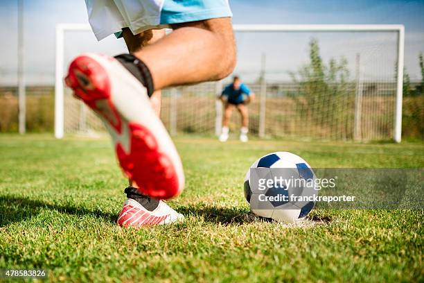 soccer player kick the ball at the penalty - shootout stock pictures, royalty-free photos & images