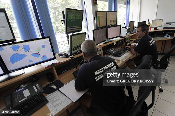 Members of the Maritime Rescue Coordination Center watch computer screens on June 25, 2015 two days after Swiss yachtsman Laurent Bourgnon was...
