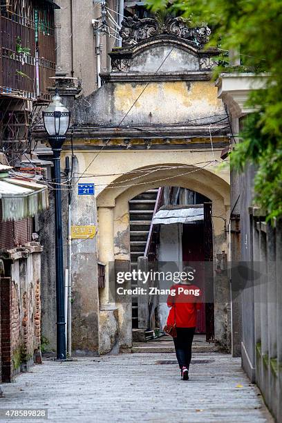 Girl walks back to a family hotel renovated from a historical building. Kulangsu is an island off the coast of Amoy city. After the First Opium War,...