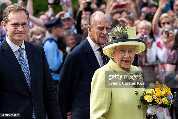 Berlin's Major Michael Mueller leads Queen Elizabeth II and Prince Philip, Duke of Edinburgh past the Brandenburg Gate on the final day of a four day...