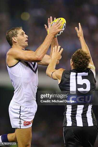 Aaron Sandilands of the Dockers marks the ball against Jarrod Witts of the Magpies during the round one AFL match between the Collingwood Magpies and...