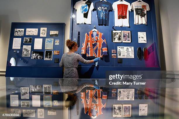 Curator dusts a cabinet containing one of Paul Weller's iconic jackets, featured in 'The Jam: About the Young Idea' at Somerset House on June 25th,...