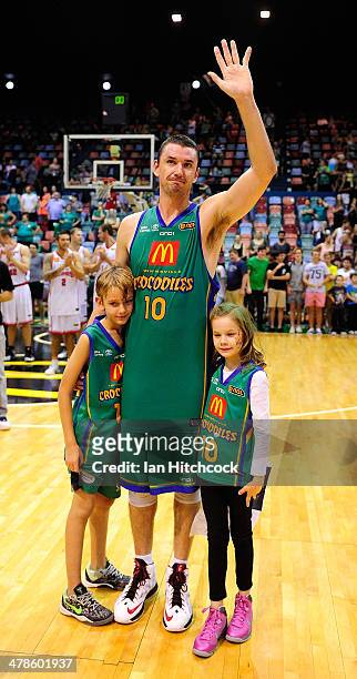 Russell Hinder of the Crocodiles waves to the crowd with his children in his last home game before retirement at the end of the round 22 NBL match...
