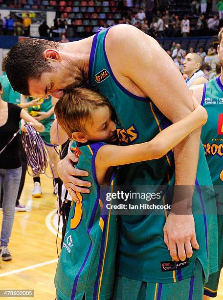 Russell Hinder of the Crocodiles is embraced by his son in his last home game before retirement at the end of the round 22 NBL match between the...