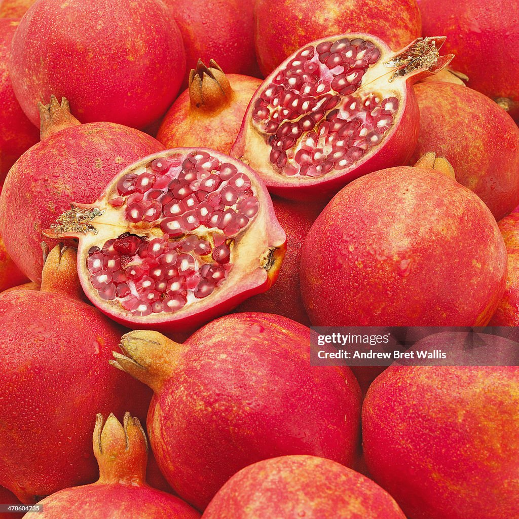 Whole and halved pomegranates