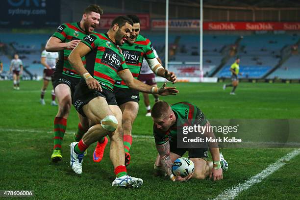 Chris McQueen,Greg Inglis and Bryson Goodwin of the Rabbitohs celebrate with Aaron Gray of the Rabbitohs after he scored a try during the round 16...