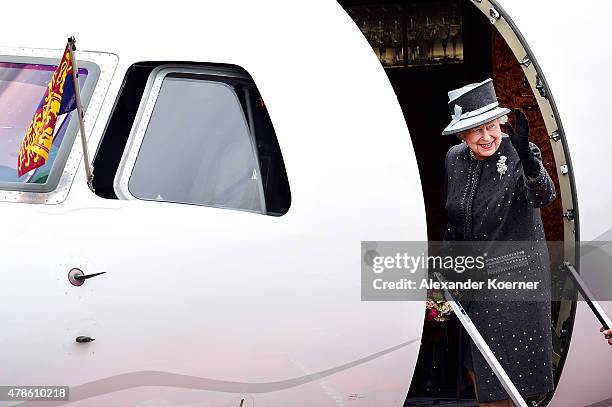 Queen Elizabeth II waves to the public while boarding an aircraft at the military airport of Celle on June 26, 2015 in Celle, Germany. The Royal...