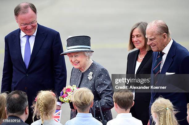 Prime Minister of the state of Lower Saxony Stephan Weil , Queen Elizabeth II and Prince Philip, Duke of Edinburgh, arrive at the military airport of...