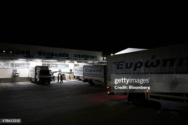 Trucks sit in a loading bay to collect editions of the Kathimerini newspaper for distribution to retail outlets at the Kathimerini Publishing SA...