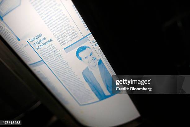 An image of Alexis Tsipras, Greece's prime minister, sits on a metal print sheet during the printing of a sports newspaper at the Kathimerini...