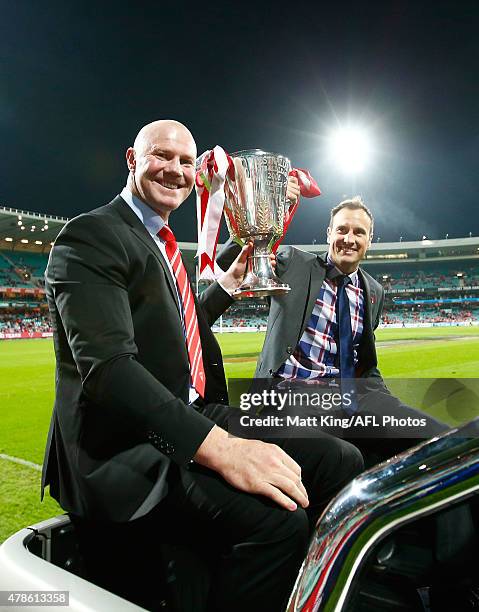 Sydney Swans premiership winning players Barry Hall and Jude Bolton take part in a lap of honour before the round 13 AFL match between the Sydney...